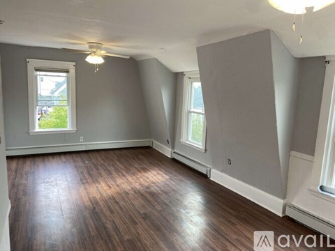 A room with wooden floors and a window.