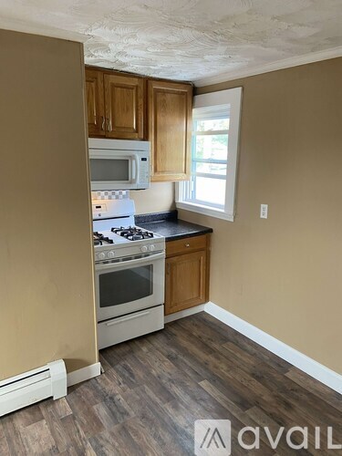 A kitchen with a stove, oven, and microwave.