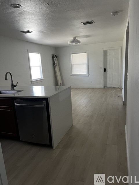 A kitchen with a sink and a dishwasher.