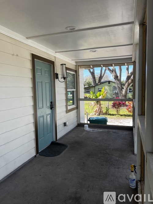 A blue door is on the left side of a white wall.