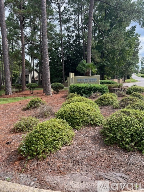 A sign that says "The Forties" is surrounded by green bushes and trees.