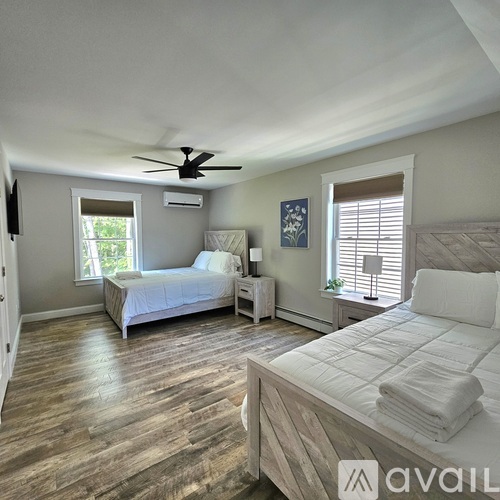 A bedroom with a large bed and a smaller bed in the corner.