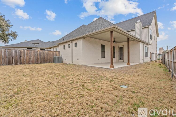 A house with a fenced yard is for sale.