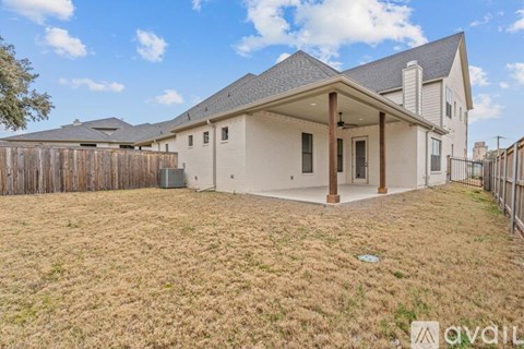 A house with a fenced yard is for sale.