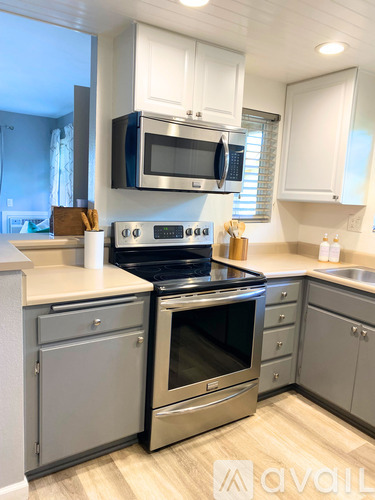 A modern kitchen with a stainless steel oven and microwave.