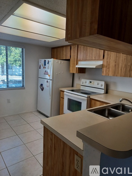 A kitchen with a white fridge and a white stove top oven.