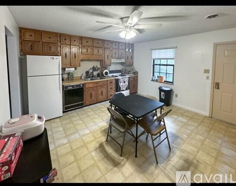 A kitchen with a table and chairs in the middle of the room.