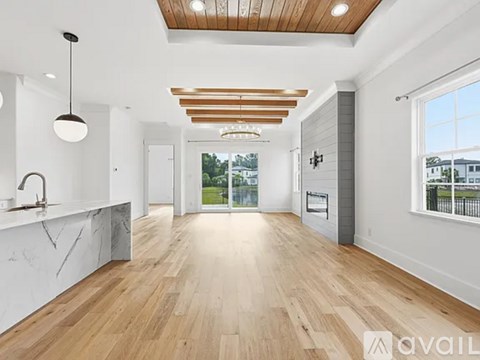 A spacious living room with wooden floors and a marble countertop.