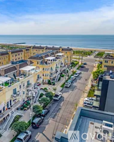 A view of a coastal town with buildings and cars.