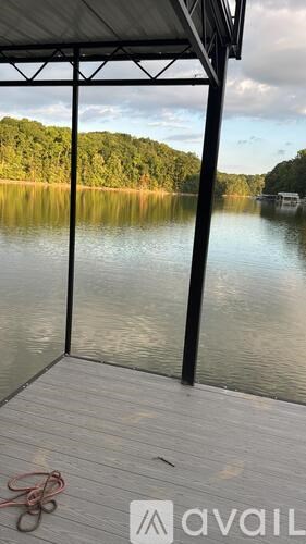 A dock with a view of a lake and trees.