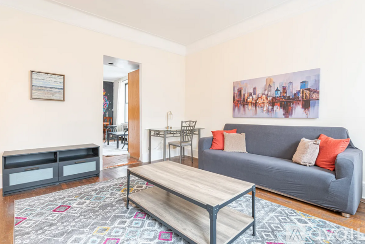 A living room with a grey couch and a coffee table.