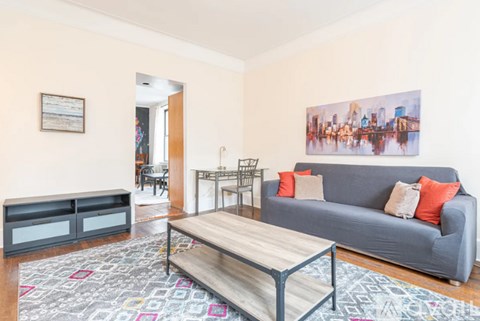 A living room with a grey couch and a coffee table.
