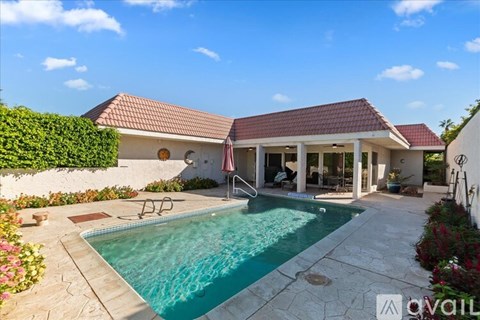 A house with a pool in the backyard.