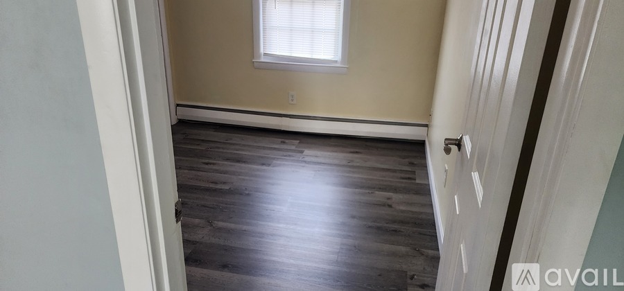 A room with wooden floors and a window.