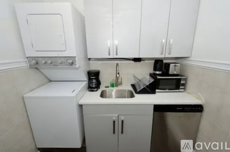 A small kitchen with a sink, a microwave, and a dishwasher.