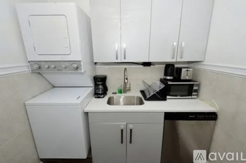 A small kitchen with a sink, a microwave, and a dishwasher.