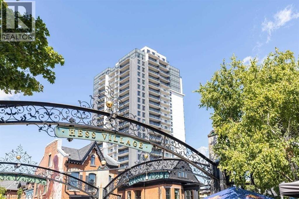 A sign that says Hess Village is in front of a building.