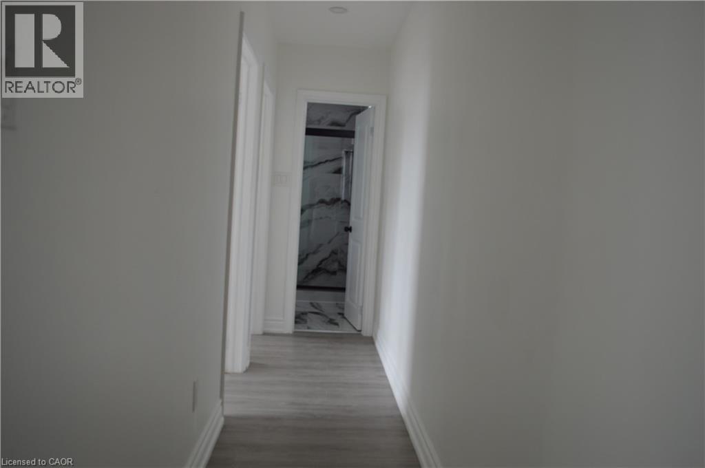 A long hallway with a door at the end.