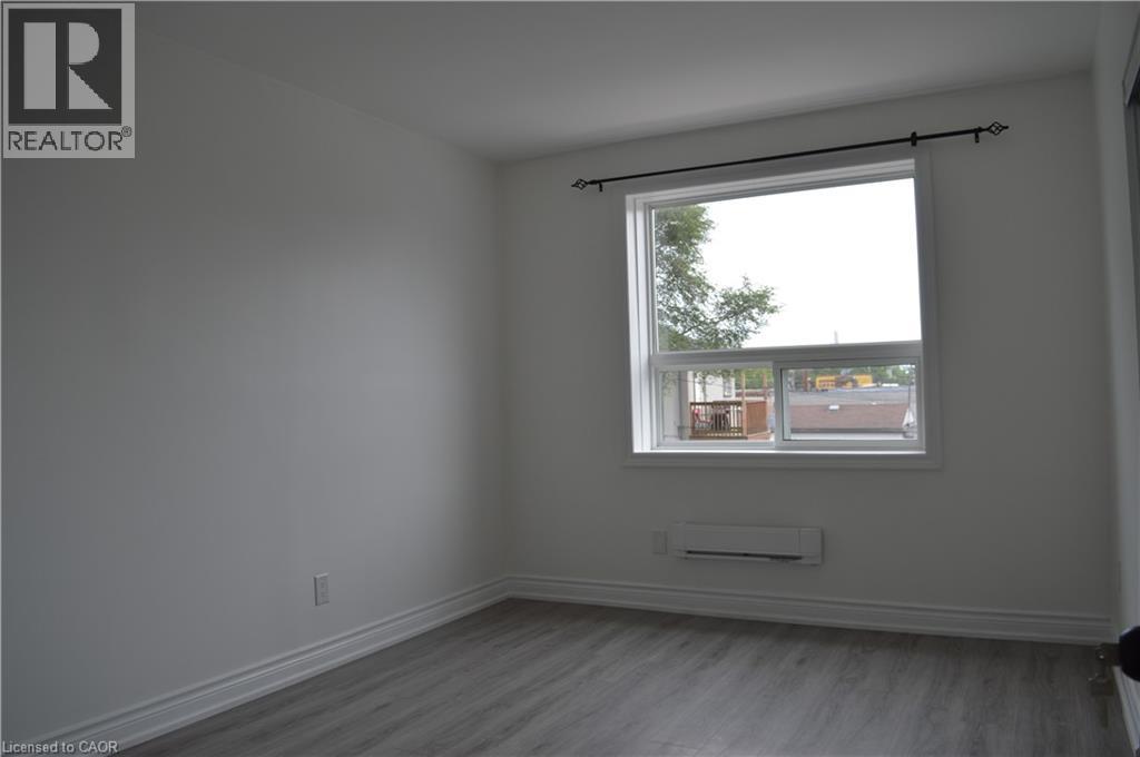 A room with a window and a wall socket.