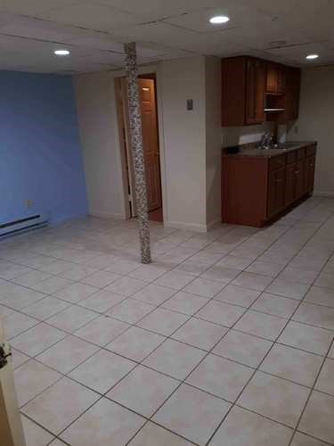 A room with a blue wall and a white tile floor.