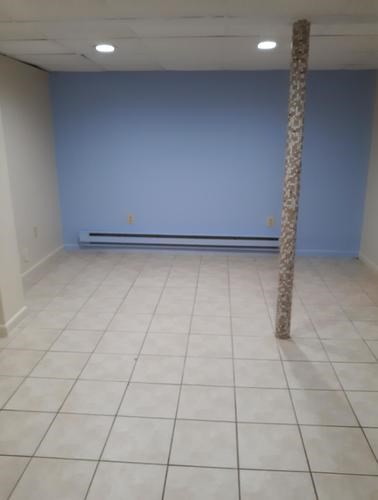 A room with a blue wall and a white tile floor.