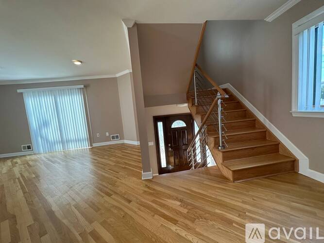 A house with a brown door and windows is for sale.