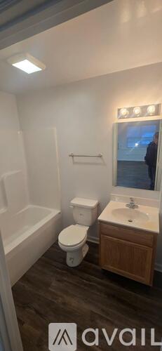 A bathroom with a toilet, sink, and bathtub.