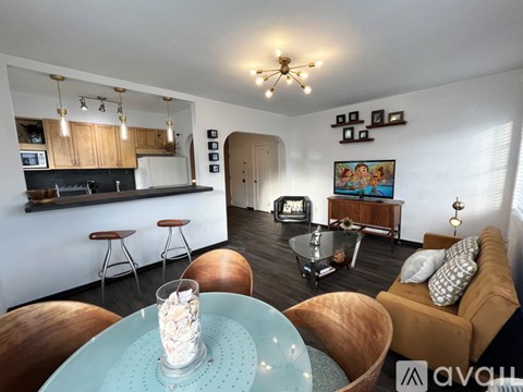 A modern living room with a glass table and a couch.