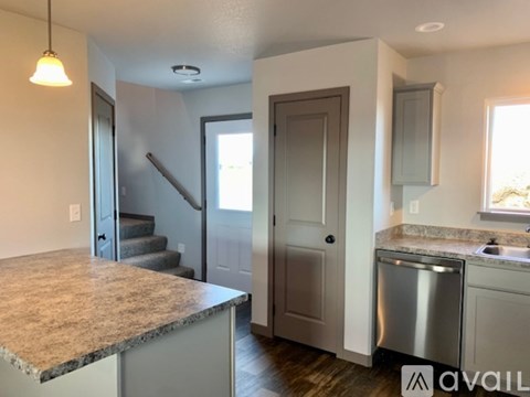 A kitchen with granite countertops and stainless steel appliances.