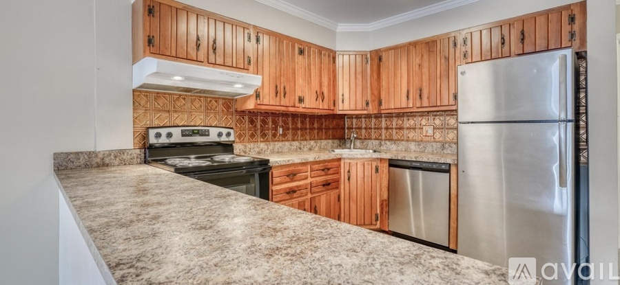 A kitchen with wooden cabinets and a granite countertop.