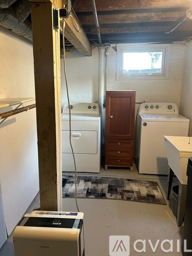 A dirty laundry room with a washer and dryer.