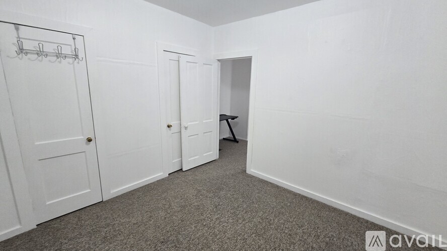 A room with a carpeted floor and white walls.