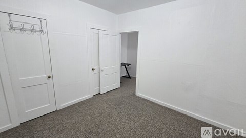A room with a carpeted floor and white walls.