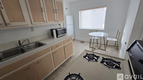 A kitchen with a stove top oven and a microwave.