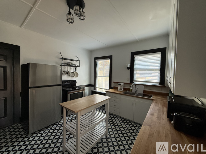 A kitchen with a black and white checkered floor.
