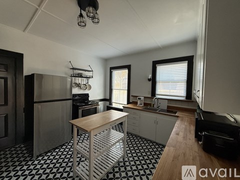 A kitchen with a black and white checkered floor.