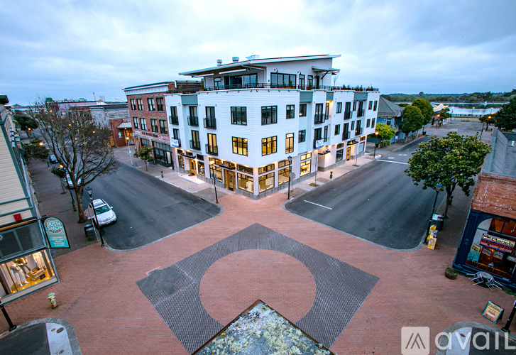 A large white building with a circular design in front of it.