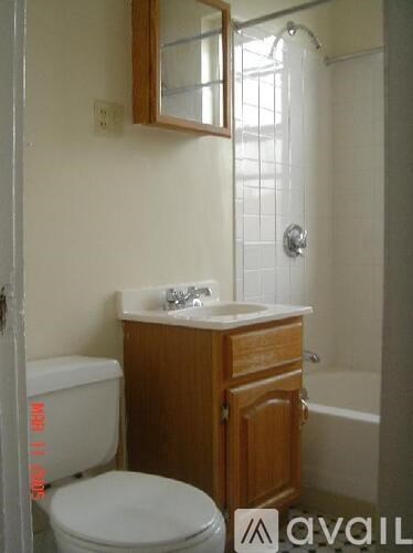 A bathroom with a toilet, sink, and shower.