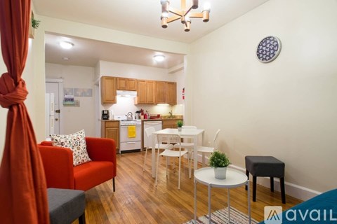 A living room with a red couch and a white table.
