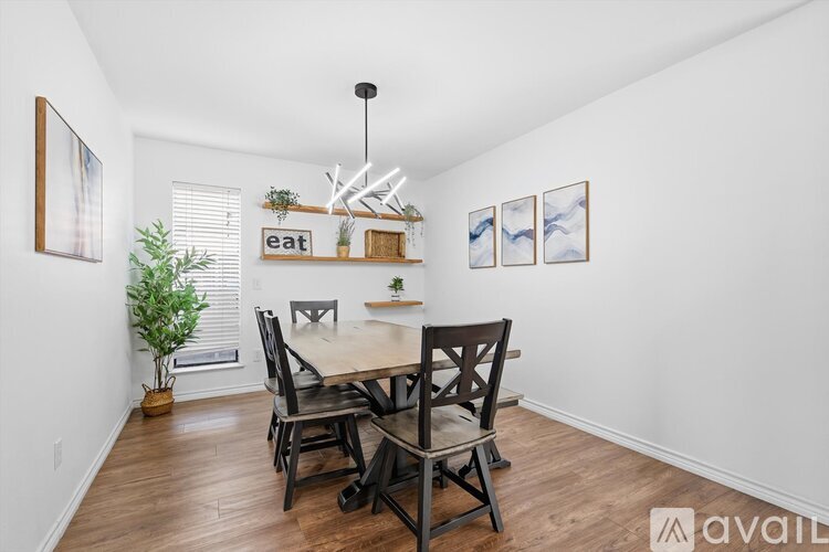 A dining room with a wooden table and chairs.