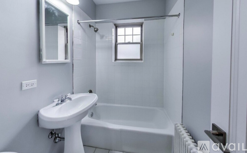 A white sink and bathtub in a bathroom.