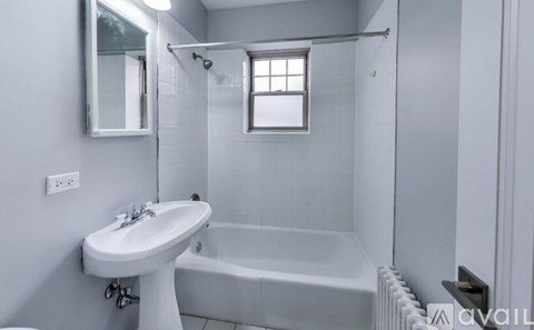 A white sink and bathtub in a bathroom.