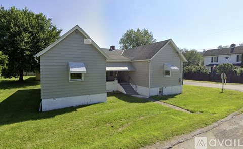 A two-story house with a garage is for sale.
