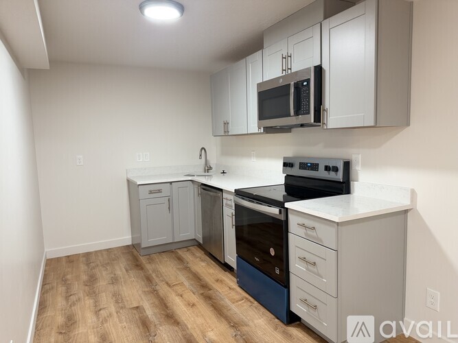 A kitchen with a stove top oven and microwave.
