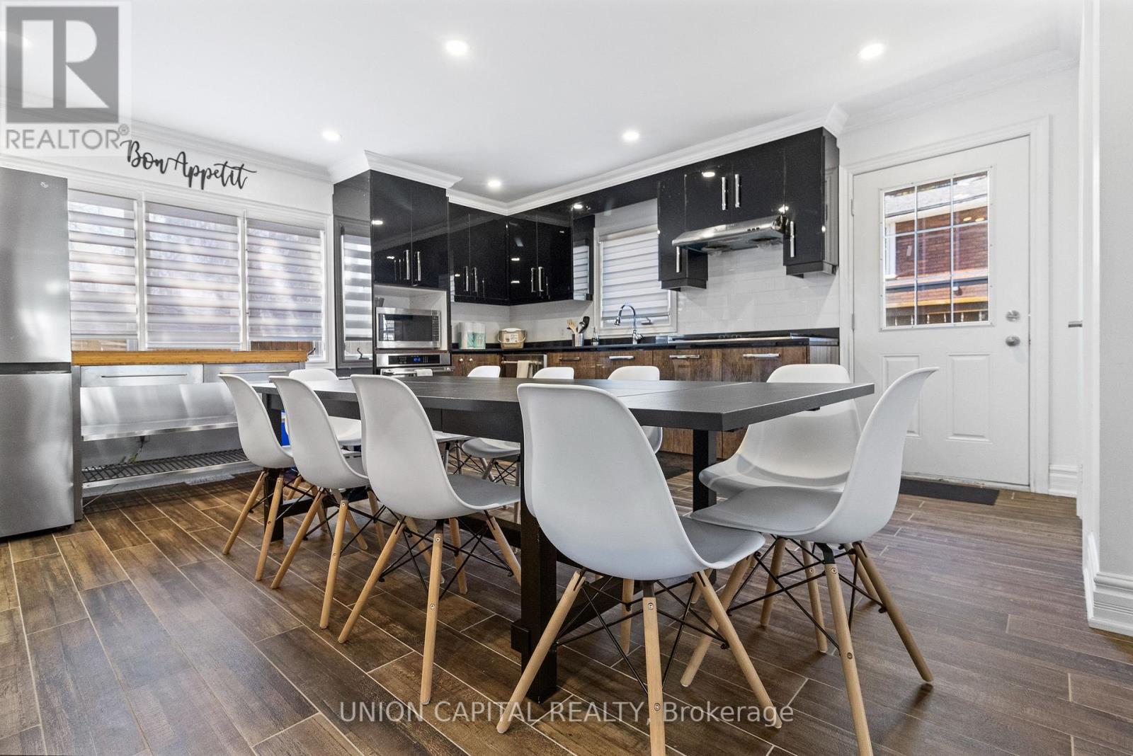 A modern kitchen with a dining table and chairs.