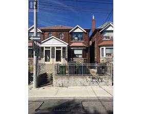 A house with a gate and a sign that says "REALTOR".