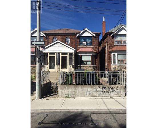 A house with a gate and a sign that says "REALTOR".