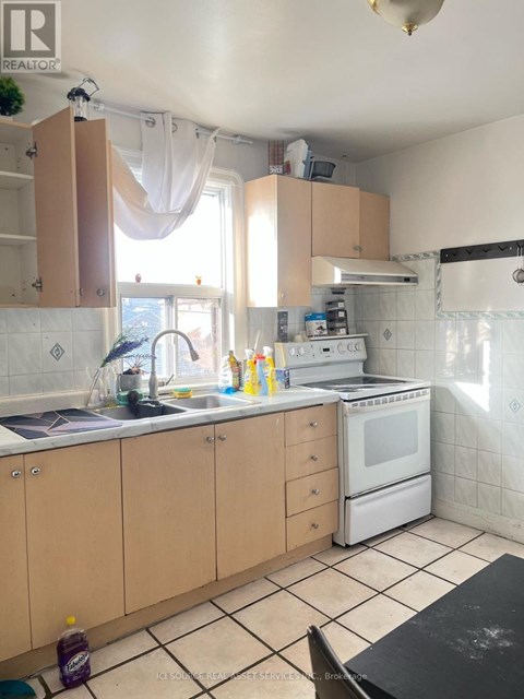 A kitchen with a white oven and a black counter.