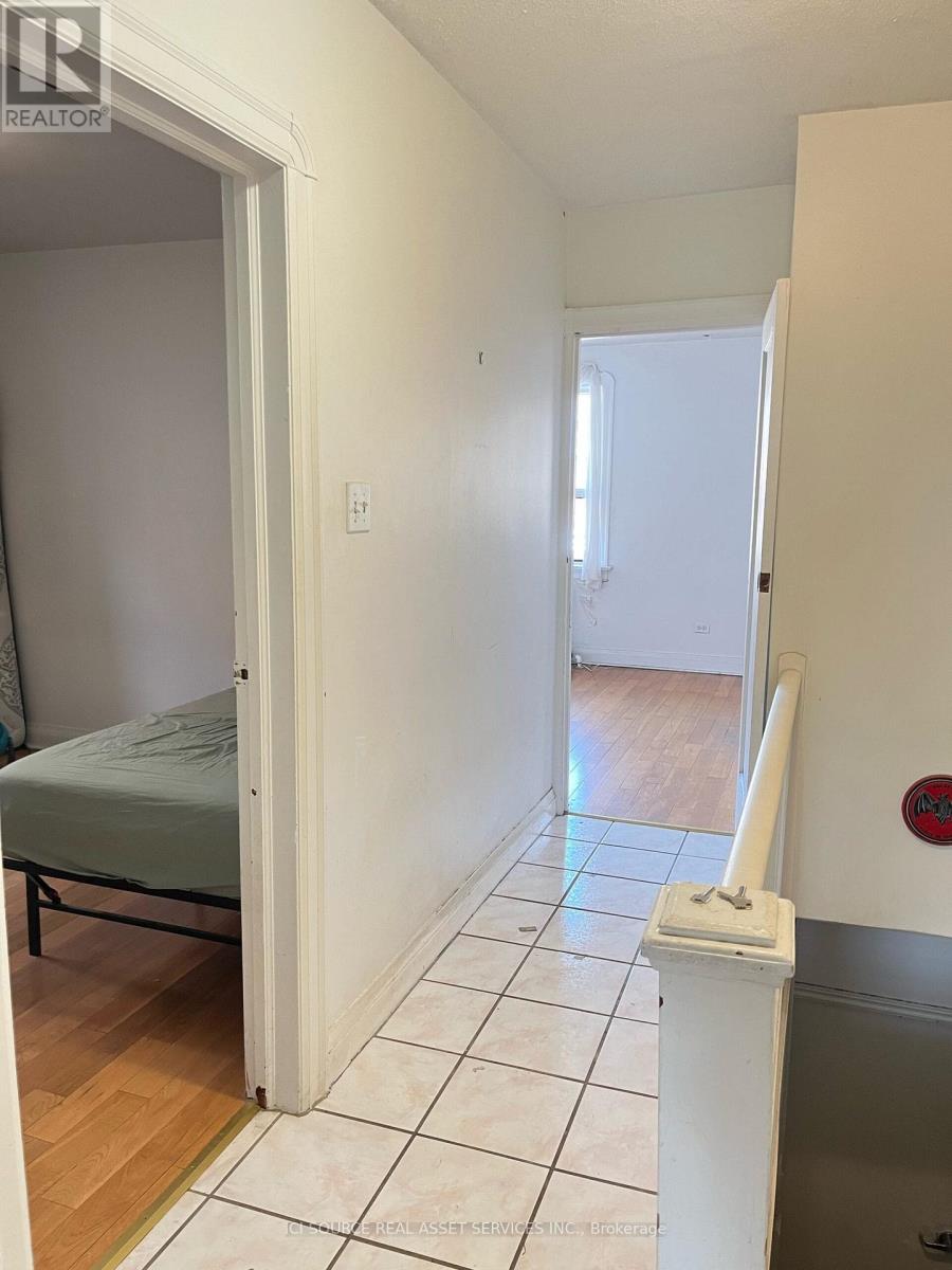 A bedroom with a bed and a toilet paper holder.