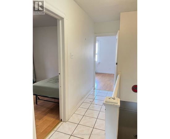 A bedroom with a bed and a toilet paper holder.